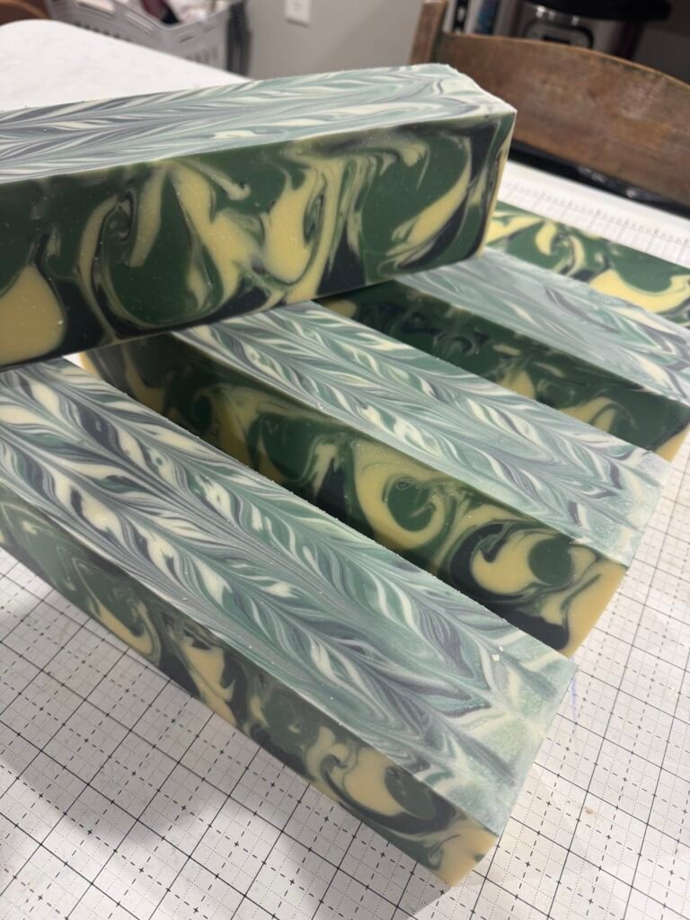 Freshly cut loaves of Go Birds soap with green, white and yellow swirls